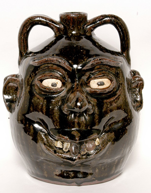 Double face jug by the late renowned folk artist Lanier Meaders. Image courtesy of Slotin Folk Art.